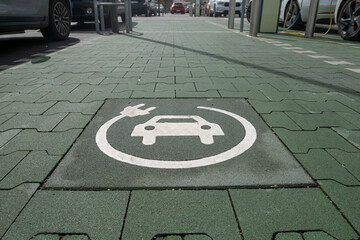 electric car, charging station is indicated by the car symbol and charging cable. per space is...