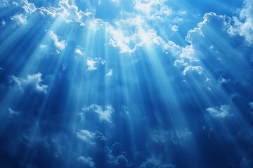 A clear sky dotted with fluffy white clouds. The sunlight filters through the clouds, casting a warm glow over the landscape. The scene radiates tranquility and serenity.