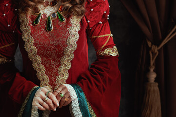 Closeup on medieval queen in red dress with jewellery - 774166587