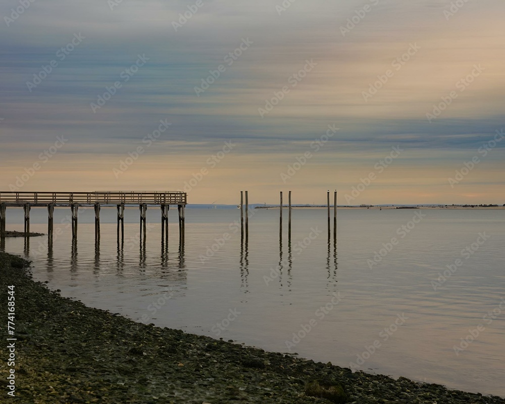 Canvas Prints Pier at sunset surrounded by serene waters