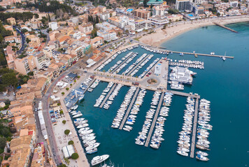 Fototapeta na wymiar Breathtaking Aerial Perspective of the Mediterranean Sea Harbor, Overflowing with Magnificent Luxury Yachts at the Bustling Marina Docks, Port de Sóller, Balearic Islands, Mallorca, Spain.