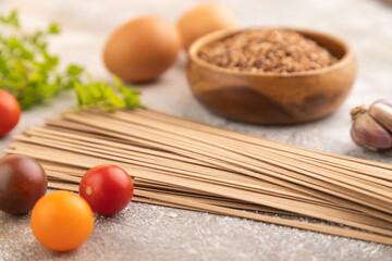 Japanese buckwheat soba noodles on brown concrete. Side view, selective focus.