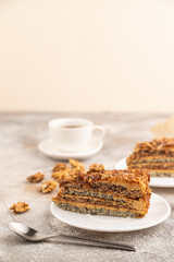 Walnut and hazelnut cake with caramel on brown concrete. side view, selective focus