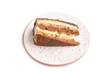 Chocolate biscuit cake with caramel cream isolated on white. side view.