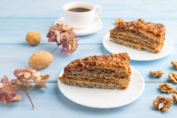 Walnut and hazelnut cake with caramel on blue wooden. side view, copy space.