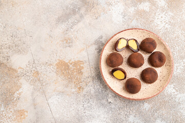 Japanese rice chocolate mochi filled with cream on brown concrete. top view, flat lay, copy space.