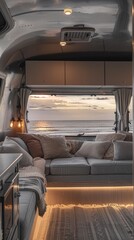 Luxurious camper interior framing a breathtaking seaside sunset view, featuring comfortable lounging spaces and modern amenities for the ultimate travel experience.