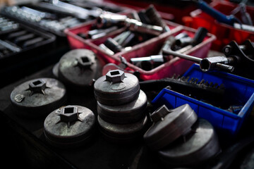A red container with many tools in it. The tools are all different sizes and shapes. The container is full of tools and looks like it has been used recently - obrazy, fototapety, plakaty