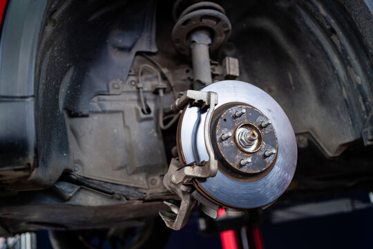 A close up of a car's wheel and tire. The wheel is silver and has a black rim. Concept of maintenance and care for the vehicle