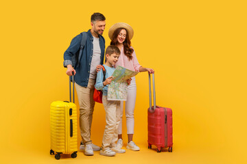 Family ready for vacation with suitcases and map