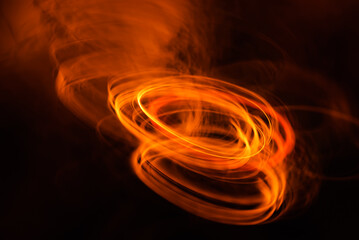 abstract background with bright orange lights on dark, long exposure