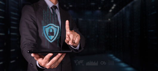 cybersecurity concept. man with tablet protects his digital information. shield icon with padlock...