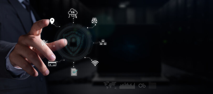 business cybersecurity concept. businessman interacts with shield hologram made of binary code. business icons