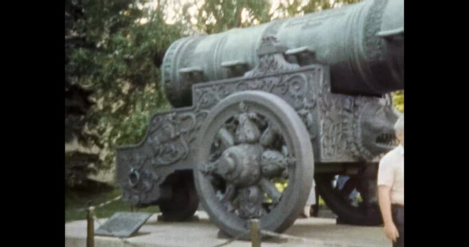 Tsar cannon historic landmark. 1980s retro Moscow, Russia. Tourist taking photo near ancient architecture monument. Tourism to history weapon museum. Archival vintage color film. Archive Travel video