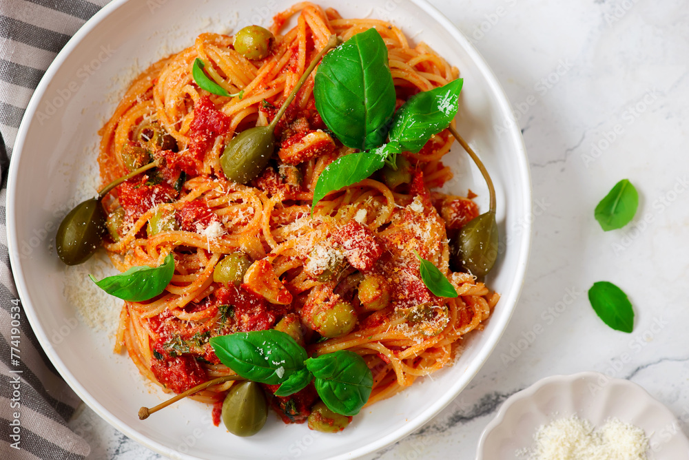 Poster pasta putaneska, with tomato sauce and basil .top veiw.selective focus