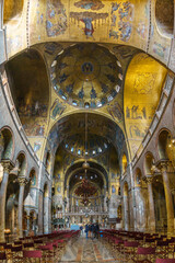 Fototapeta na wymiar Golden wall with beautiful mosaic inside San Marco Basilica, Venice, Veneto, Italy