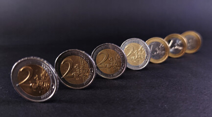 View of euro coins on a dark background, focus on the middle coin
