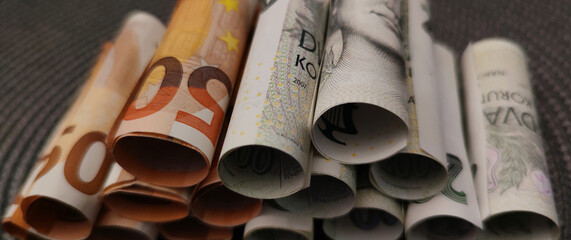 Close-up view of Euro banknotes rolled into a roll stacked on top of each other