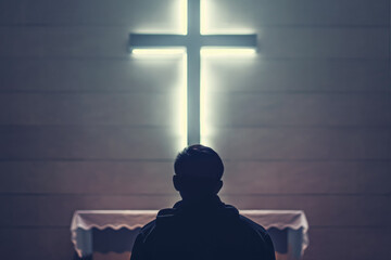 Christian man praying in front of the cross - 774195189