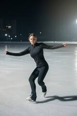 Beautiful young woman ice skating