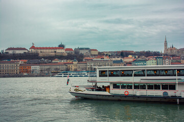 Fototapeta na wymiar A ship on the Danube river with a view of the city