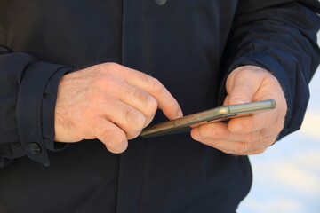 A man uses a smartphone.Hands close-up.