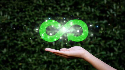Hand hold the circular economy icon,  infinity symbol resting.The concept of eternity, endless and...