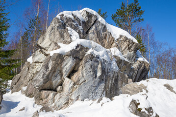 Marble rock in Ruskeala Mountain Park on a sunny March day. Karelia, Russia - 774211980