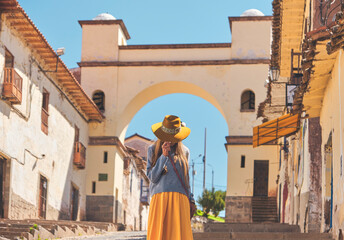 Young woman traveler in brown hat on the street, Cusco Peru. Copy space. Stepping Into Another...