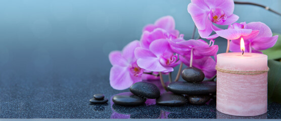 Spa background with pink orchid , candle and zen black stones on gray. - 774221511