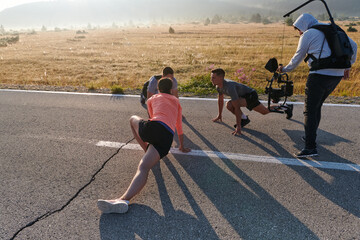 Behind the Lens: Videographer Captures Athletes Warming Up for Morning Run. - 774231136