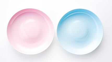 Two plates, one pink and one blue, sit on a white background