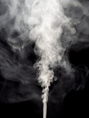 Jet of white smoke steam or abstract white smog isolated on a black and rising up