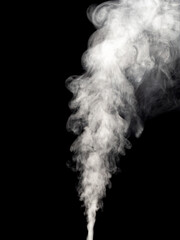 Jet of white smoke rises, streams and forms tubers isolated on a black