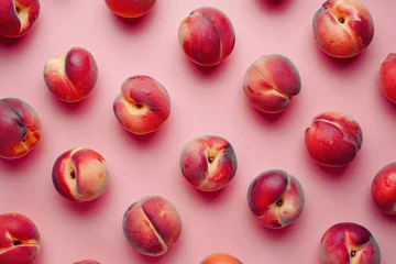 Poster Pattern of ripe peaches on pink background © Alina