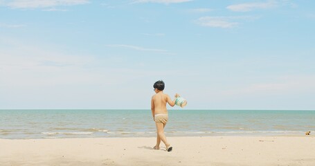 active happy cute Asian children boy enjoy leisure summer vacation holiday travel walking on...