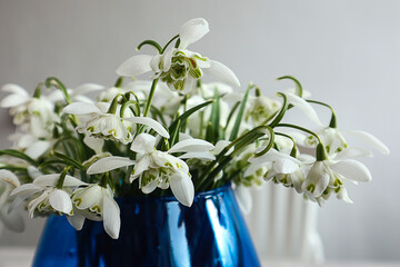 Spring bouquets: a bouquet of snowdrops in a blue vase, close-up