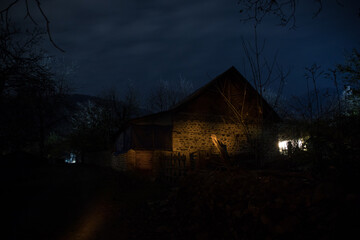 Old house with a Ghost in the forest at misty night or Night scene with House under moon. Old...