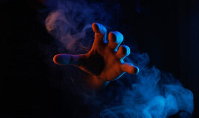 Mystical smoke in scary hands. Mysterious composition. Fortune teller, mind power, prediction,...