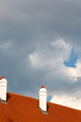Chimneys on the roof of the house against the sky