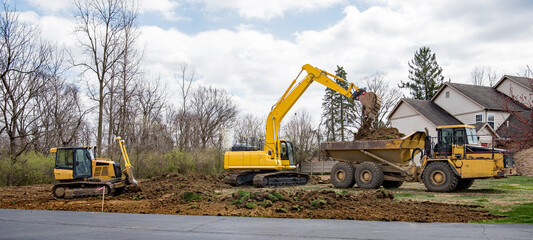 Land Excavation Panorama with Bulldozer, Backhoe and Truck