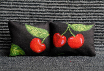 Black cushions with red cherry pattern
