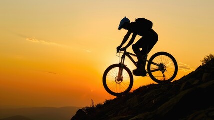 Obraz premium silhouette of Mountain biker riding downhill