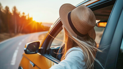 Young woman driving a car traveling. Golden sunlight. Freedom wanderlust adventure traveling concept