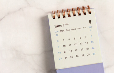 Desktop calendar for June 2024 on a light background.