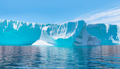 Melting icebergs by the coast of Greenland, on a beautiful summer day - Melting of a iceberg and pouring water into the sea - Greenland - iceberg breaking away from a large glacier