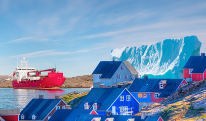 Arctic Ship leaving Tasiilaq after having unloaded at the docks in the harbour - Tasiilaq, Greenland