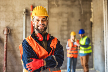 Construction site manager standing  wearing safety vest and helmet, thinking at construction site....
