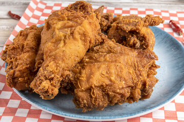 deep fried southern style chicken pieces on a blue plate