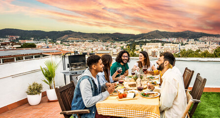 Happy friends having barbecue dinner party at home balcony - Young people enjoying lunch break at...